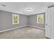 Neutrally painted bedroom featuring two windows allowing natural light at 4301 Hidden Valley Rd, Decatur, GA 30035