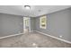 Neutral bedroom with two windows providing natural light and easy bathroom access at 4301 Hidden Valley Rd, Decatur, GA 30035