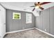 Small gray painted bedroom featuring two windows and a ceiling fan at 4301 Hidden Valley Rd, Decatur, GA 30035