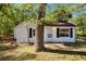 Charming single-story home featuring white exterior, black shutters and a well-maintained front yard at 4301 Hidden Valley Rd, Decatur, GA 30035