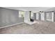 Spacious living room featuring a fireplace, neutral paint, and plush carpeting at 4301 Hidden Valley Rd, Decatur, GA 30035