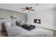 Cozy living room featuring a fireplace, ceiling fan, and comfortable seating arrangement at 4301 Hidden Valley Rd, Decatur, GA 30035