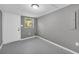 Small room painted gray featuring a window and an exit door at 4301 Hidden Valley Rd, Decatur, GA 30035