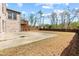 Spacious backyard with concrete patio, wooden deck, and lawn at 4466 Woodland Bank Blvd, Buford, GA 30518