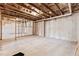 Unfinished basement with exposed ceiling, framing, and windows offers potential for customization at 4466 Woodland Bank Blvd, Buford, GA 30518