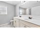 Bright bathroom features a double vanity with modern fixtures and a large mirror reflecting the shower at 4466 Woodland Bank Blvd, Buford, GA 30518
