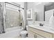 Well-lit bathroom with tub and shower combination, tile surround and modern fixtures at 4466 Woodland Bank Blvd, Buford, GA 30518