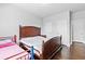 Bedroom features hardwood floor, gray walls, large bed, two closets, and an attached bath at 4466 Woodland Bank Blvd, Buford, GA 30518