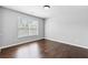 A light and bright bedroom with hardwood floors and a large window for lots of natural light at 4466 Woodland Bank Blvd, Buford, GA 30518