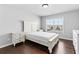 Cozy bedroom with hardwood floors, natural light, and white furniture set for comfort at 4466 Woodland Bank Blvd, Buford, GA 30518