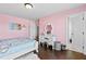 This pink bedroom features hardwood floors and plenty of light at 4466 Woodland Bank Blvd, Buford, GA 30518