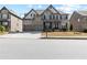 Charming two-story home with brick and stone exterior, well-maintained lawn, and attached two-car garage at 4466 Woodland Bank Blvd, Buford, GA 30518