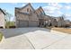 Charming two-story home with brick and stone exterior, well-maintained lawn, and attached two-car garage at 4466 Woodland Bank Blvd, Buford, GA 30518