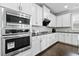 Gourmet kitchen with stainless steel oven, microwave, and white custom cabinetry at 4466 Woodland Bank Blvd, Buford, GA 30518