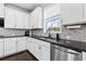 Modern kitchen featuring white cabinets, granite countertops, and stainless steel appliances at 4466 Woodland Bank Blvd, Buford, GA 30518