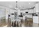 Open-concept kitchen with granite countertops, stainless steel appliances, and an island with bar seating at 4466 Woodland Bank Blvd, Buford, GA 30518