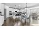 Spacious kitchen features an island with bar seating, white cabinets, stainless steel appliances, and hardwood floors at 4466 Woodland Bank Blvd, Buford, GA 30518