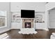 A stone fireplace and built-in shelving create a focal point in this modern living room at 4466 Woodland Bank Blvd, Buford, GA 30518