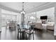 Open-concept living and dining area with hardwood floors and fireplace at 4466 Woodland Bank Blvd, Buford, GA 30518