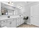 Bright bathroom featuring double vanity, tile floors, and white cabinets at 4466 Woodland Bank Blvd, Buford, GA 30518