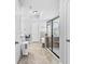 This bathroom has tile floors, tub, glass shower and white cabinets at 4466 Woodland Bank Blvd, Buford, GA 30518