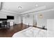 This large main bedroom features tray ceilings, wood floors and adjacent bathroom access at 4466 Woodland Bank Blvd, Buford, GA 30518