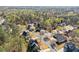 Aerial view of a neighborhood with lush green trees and manicured lawns on a sunny day at 5381 Fawn Meadow Ln, Powder Springs, GA 30127