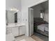 En suite bathroom leads to the bedroom with a view of the elegant white vanity with storage at 5381 Fawn Meadow Ln, Powder Springs, GA 30127