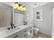 Bright bathroom features a double vanity with modern fixtures and bright lighting above the mirror at 5381 Fawn Meadow Ln, Powder Springs, GA 30127