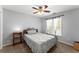 Gray bedroom features neutral carpet, a ceiling fan, and a bed with a gray patterned comforter at 5381 Fawn Meadow Ln, Powder Springs, GA 30127