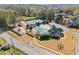 A stunning view of a community pool, playground, and clubhouse with lush landscaping for residents to enjoy at 5381 Fawn Meadow Ln, Powder Springs, GA 30127