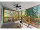 Covered deck with wood railings offers shade and a view of the landscaped backyard at 5381 Fawn Meadow Ln, Powder Springs, GA 30127