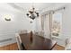Dining room with a contemporary chandelier, ample natural light, and classic wall details at 5381 Fawn Meadow Ln, Powder Springs, GA 30127