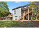 Exterior view of a home featuring a deck and a large backyard perfect for outdoor entertaining at 5381 Fawn Meadow Ln, Powder Springs, GA 30127