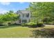 Two-story home showcasing lush landscaping and a well-manicured lawn at 5381 Fawn Meadow Ln, Powder Springs, GA 30127