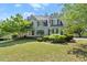 Charming two-story home with a well-maintained lawn and mature trees at 5381 Fawn Meadow Ln, Powder Springs, GA 30127
