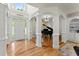 Elegant foyer featuring hardwood floors, sophisticated columns, and a grand piano at 5381 Fawn Meadow Ln, Powder Springs, GA 30127