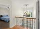 Bright hallway features hardwood floors, ornate chandelier, and staircase leading to a lower level at 5381 Fawn Meadow Ln, Powder Springs, GA 30127