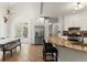Eat-in kitchen boasts stainless steel appliances, breakfast bar, tile floors and white cabinets at 5381 Fawn Meadow Ln, Powder Springs, GA 30127