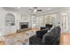 Inviting living room featuring a stone fireplace, built-in shelving, and large windows at 5381 Fawn Meadow Ln, Powder Springs, GA 30127