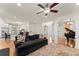 Open floor plan with kitchen view, hardwood floors and a modern ceiling fan at 5381 Fawn Meadow Ln, Powder Springs, GA 30127