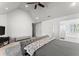 Open bedroom with vaulted ceilings, ceiling fan, and a large bed with a gray patterned bedspread at 5381 Fawn Meadow Ln, Powder Springs, GA 30127
