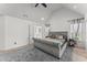 Vaulted ceiling bedroom offers a gray bedspread, neutral carpet, and a ceiling fan for added comfort at 5381 Fawn Meadow Ln, Powder Springs, GA 30127