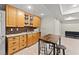 Basement wet bar features maple cabinets, granite countertops, and a convenient serving area at 5381 Fawn Meadow Ln, Powder Springs, GA 30127