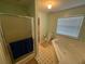 Well-lit bathroom featuring a separate shower and tub, a toilet, and a window for natural light at 221 Huntington Dr, Mcdonough, GA 30253