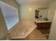 Relaxing bathroom with a soaking tub, vanity with sink, and a large window offering natural light at 221 Huntington Dr, Mcdonough, GA 30253