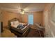 A bright bedroom with a queen bed, a ceiling fan, and a view from the window at 221 Huntington Dr, Mcdonough, GA 30253