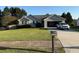 Well maintained single-Gathering home with an attached garage and lush green lawn in a quiet neighborhood at 221 Huntington Dr, Mcdonough, GA 30253