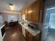 Well-appointed kitchen with wooden cabinets and modern appliances, conveniently located next to laundry room at 221 Huntington Dr, Mcdonough, GA 30253