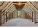 Bright attic space featuring natural light, wooden beams, and insulation, ready for customization at 3860 Rajean Dr, Lawrenceville, GA 30044
